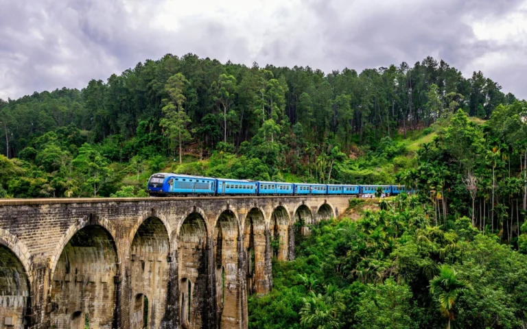 The blue hill-country train crossing the Nine Arches Bridge near Ella