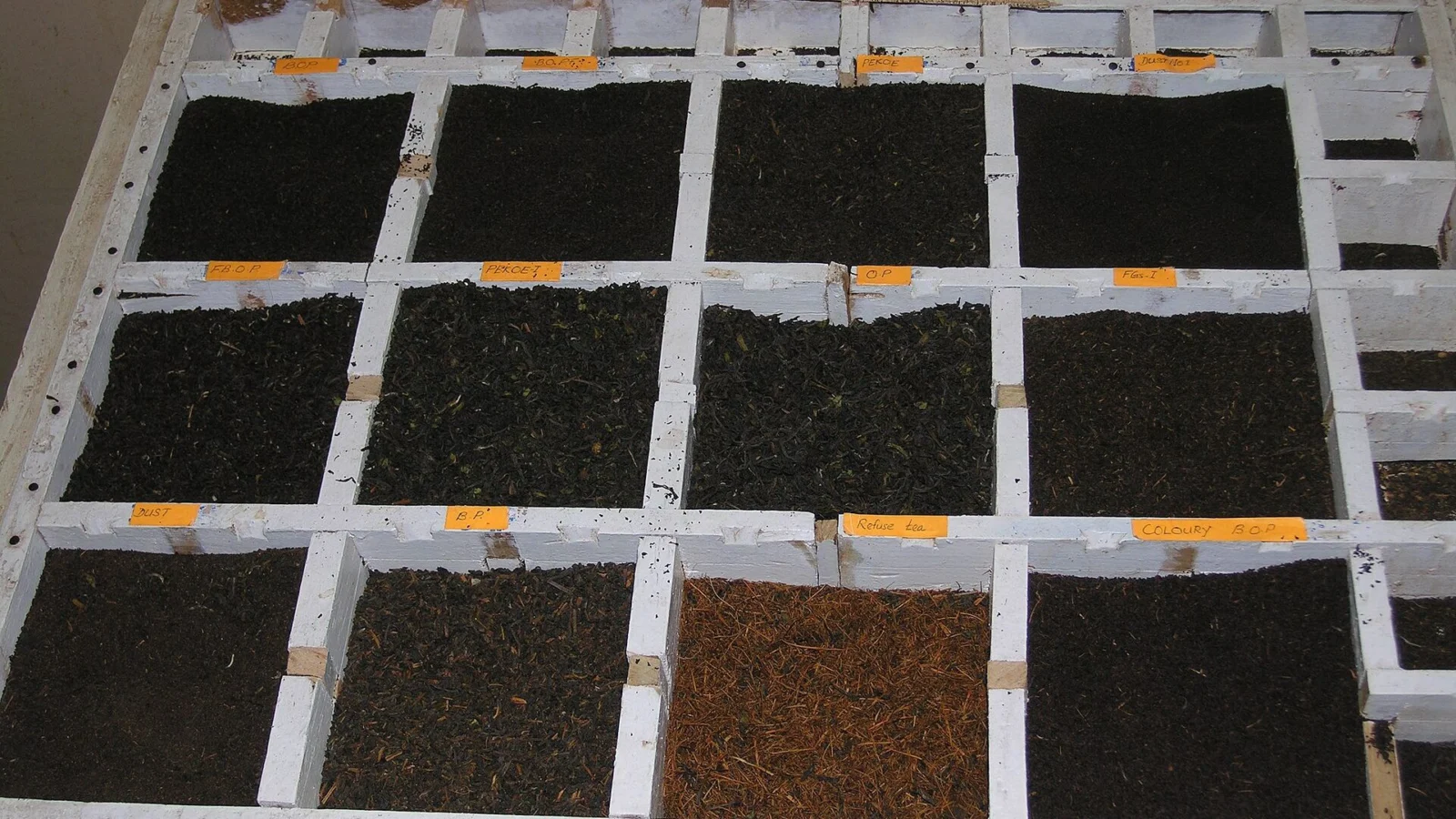 A tea factory sample case with compartments of different Ceylon tea grades