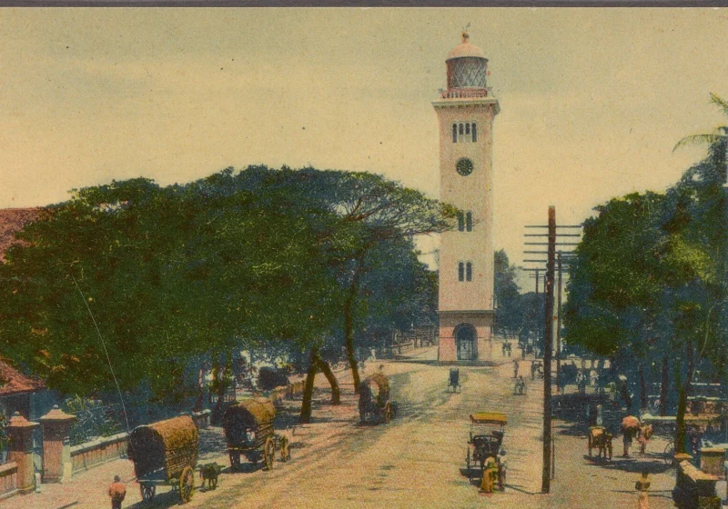 Queen Street in Colombo Fort with the old lighthouse clock tower, from a hand-coloured postcard of 1907