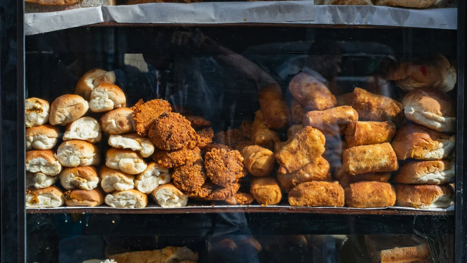 A Sri Lankan bakery display of fish buns, cutlets and rolls