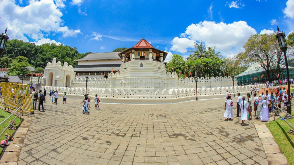 The Temple of the Sacred Tooth Relic (Sri Dalada Maligawa) in Kandy, with visitors in traditional white dress